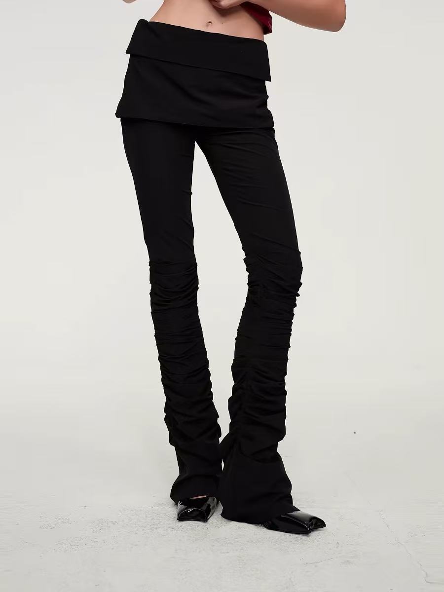 Detail of the folded waistband and ruched black trousers