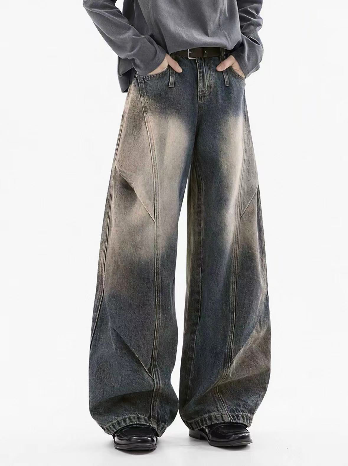Front detail of sculptural washed denim trousers
