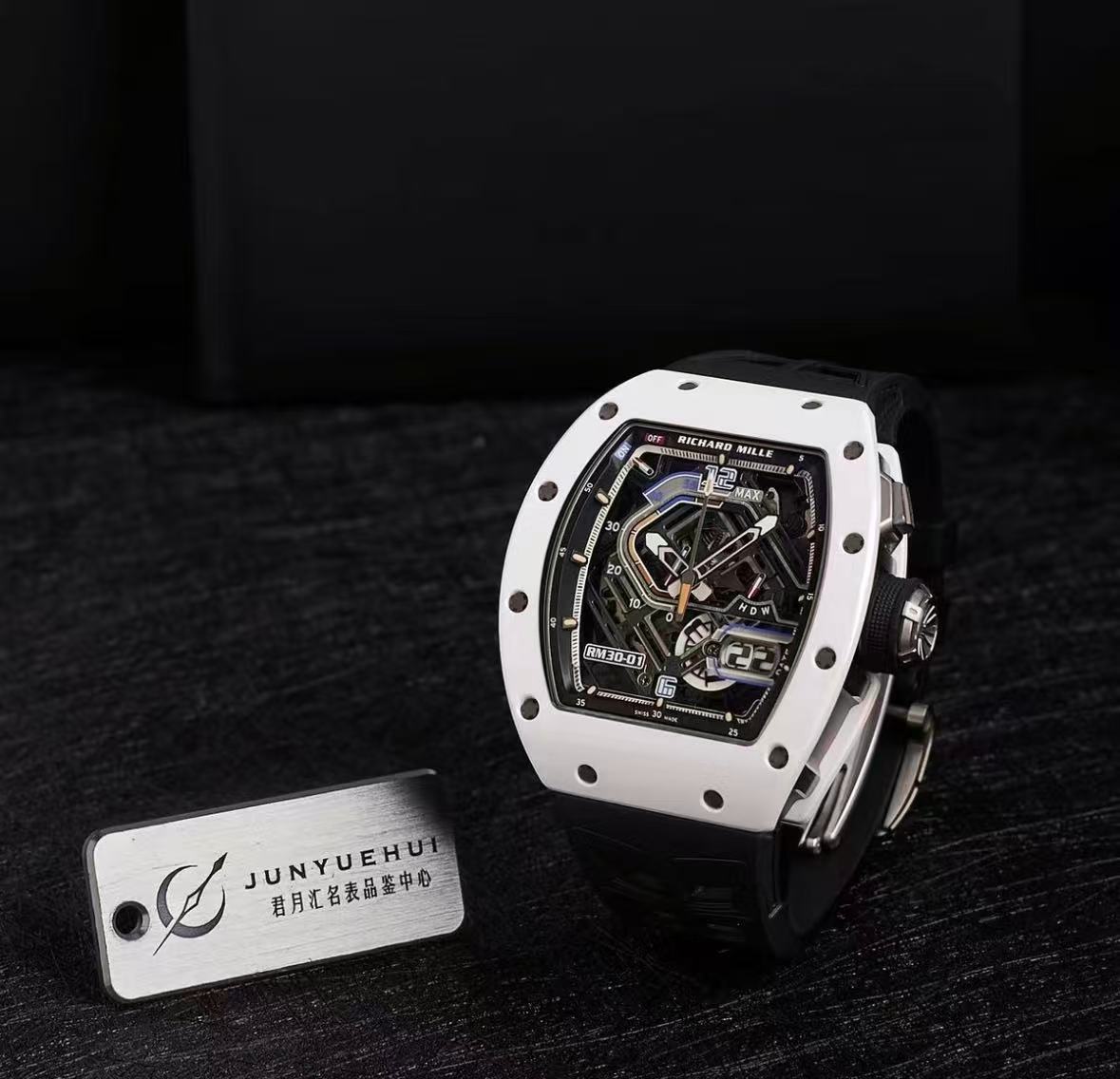 White-cased watch styled upright on a black surface